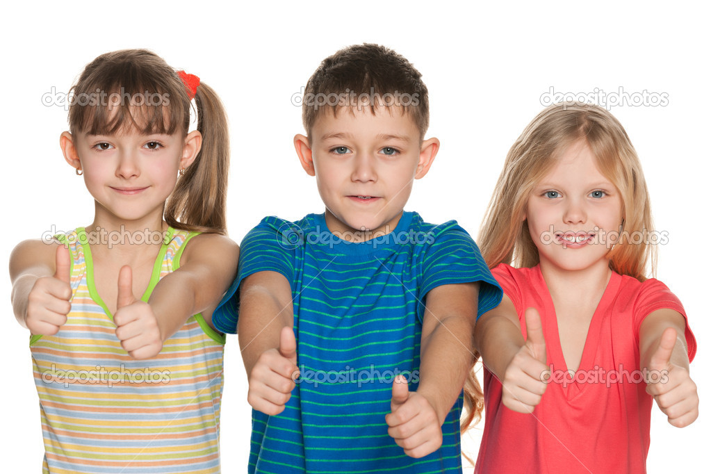 Three children hold their thumbs up