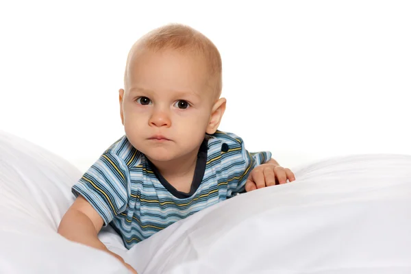Serious baby boy in the bed — Stock Photo, Image
