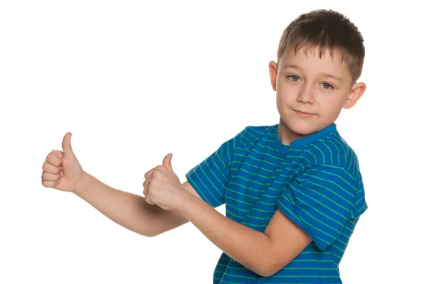 Serious boy holds his thumb — Stock Photo, Image