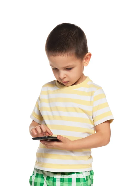 Ernstige kleine jongen met een smartphone — Stockfoto