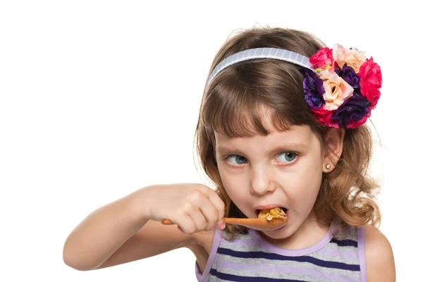 Small girl eats with a spoon — Stock Photo, Image