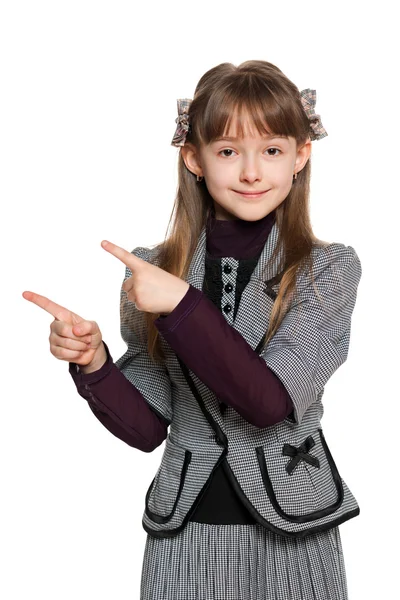 Young girl shows her finger to the side — Stock Photo, Image