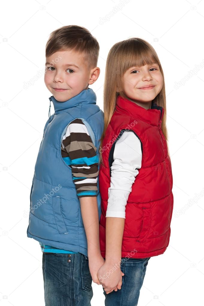 Two smiling children on the white background