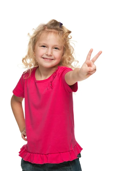 Pretty young girl makes a victory sign — Stock Photo, Image