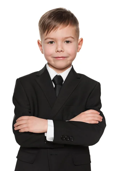 Smiling young boy in black suit — Stock Photo, Image