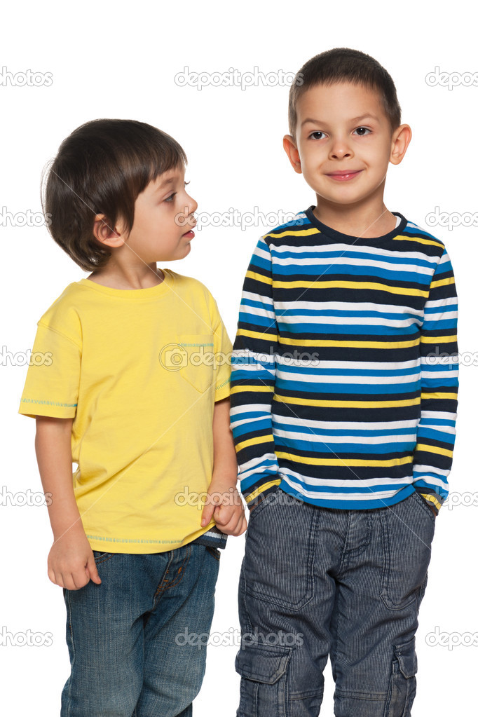 Two young boys are standing together