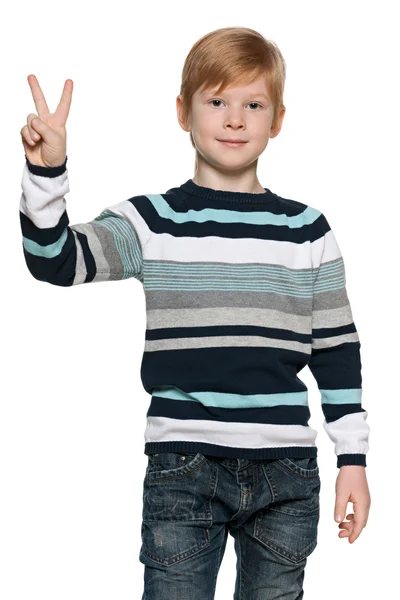 Red-haired young boy holds victory sign — Stock Photo, Image