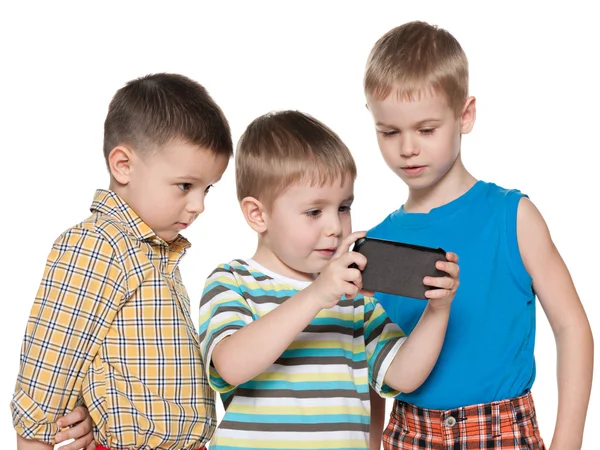 Young children plaing with a new gadget — Stock Photo, Image