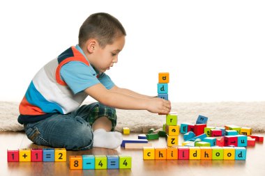 Clever preschooler is playing with toys