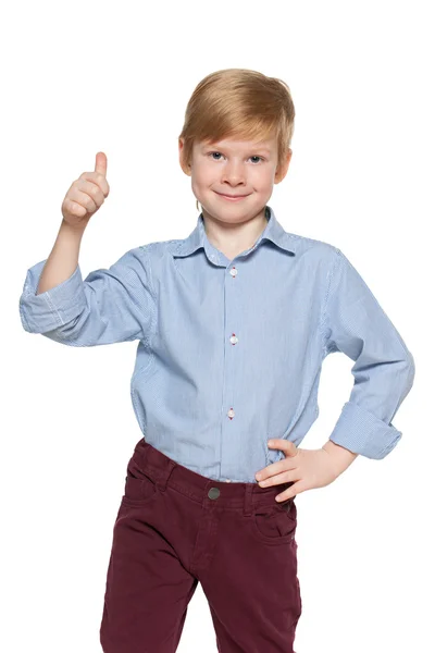 Cute young boy holds his thumb up — Stock Photo, Image