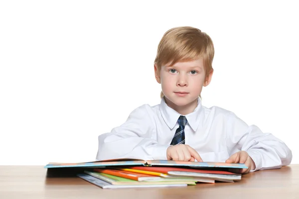 Boy is reading at the desk — Stock Photo, Image