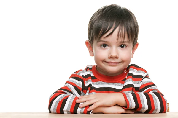 Cute little boy at the desk — Stock Photo, Image