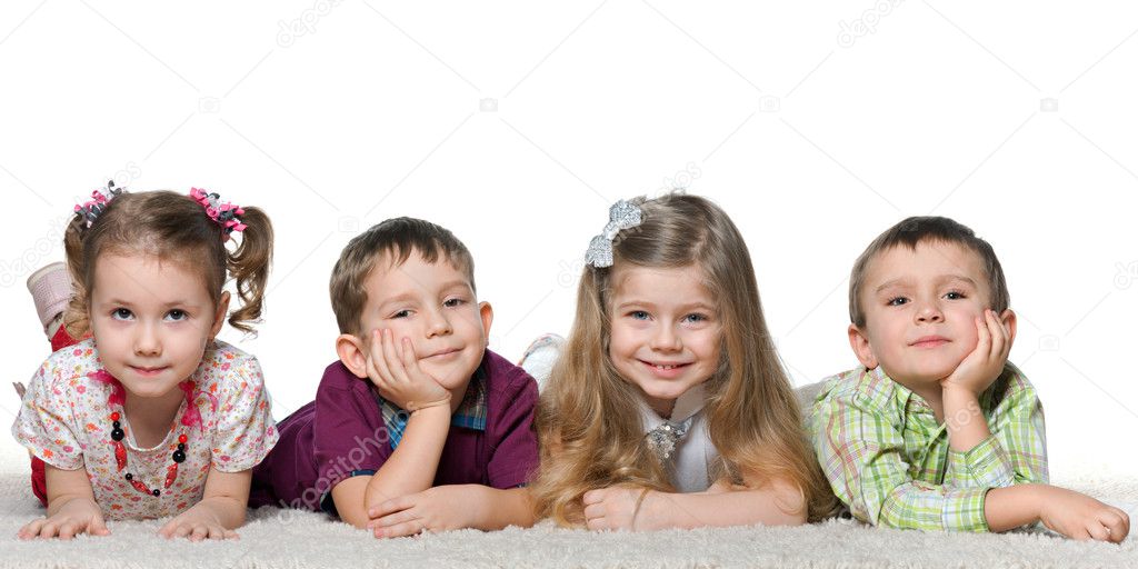 Four children lying on the carpet