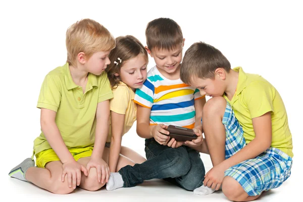 Children plaing with a new gadget — Stock Photo, Image