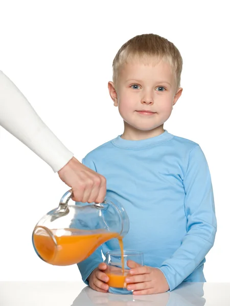 Little boy with a glass of orange juice — Stock Photo, Image