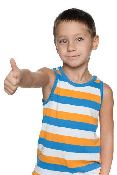 Young boy in a striped shirt holds his thumb up — Stock Photo, Image