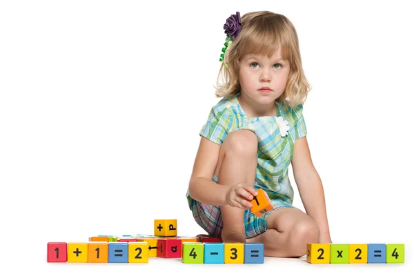 Thoughtful little girl with blocks — Stock Photo, Image