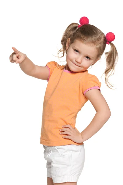 Little girl shows her finger to the side — Stock Photo, Image