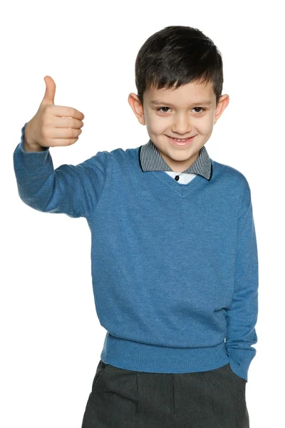 Young boy in blue pullover holds his thumb up — Stock Photo, Image