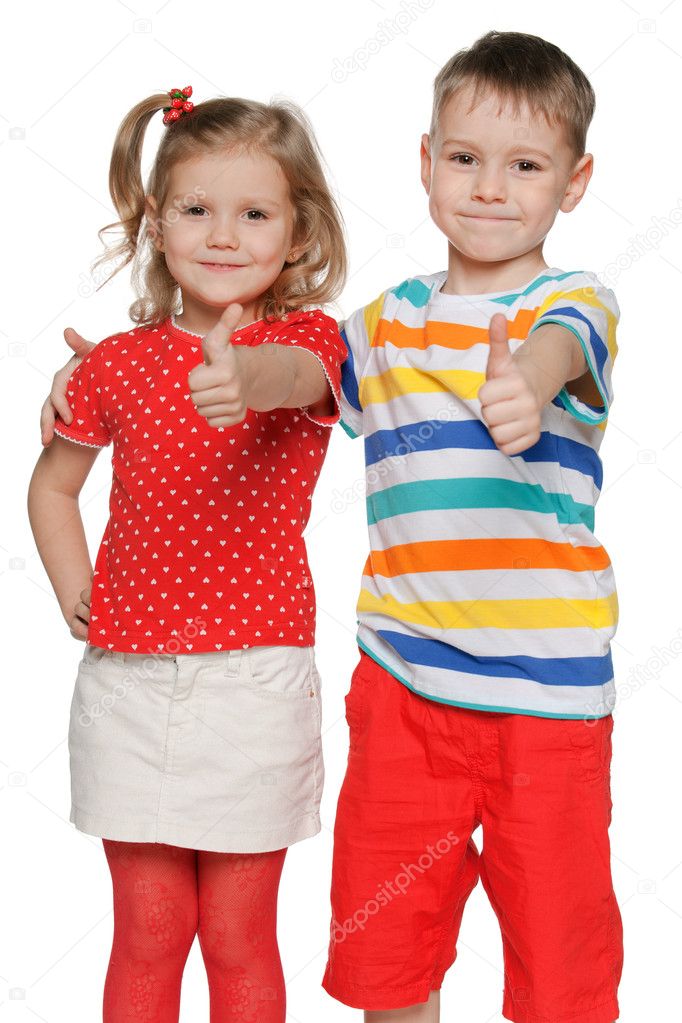 Two cheerful children hold his thumbs up