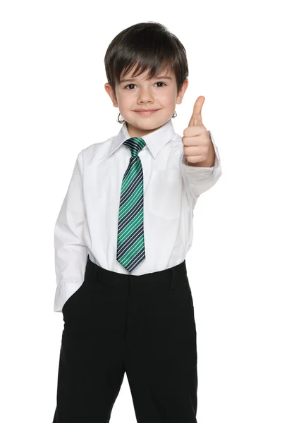 Schoolboy holds his thumb up — Stock Photo, Image