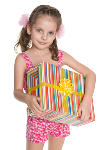 Little girl with a gift box Stock Picture