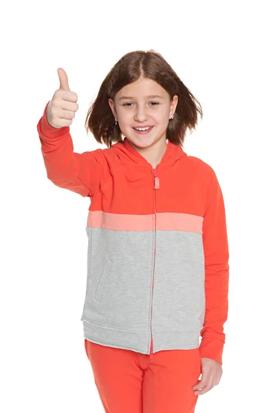 Girl in sportswear holds her thumb up — Stock Photo, Image