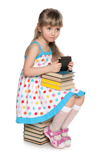 Many books or a new gadget? — Stock Photo, Image