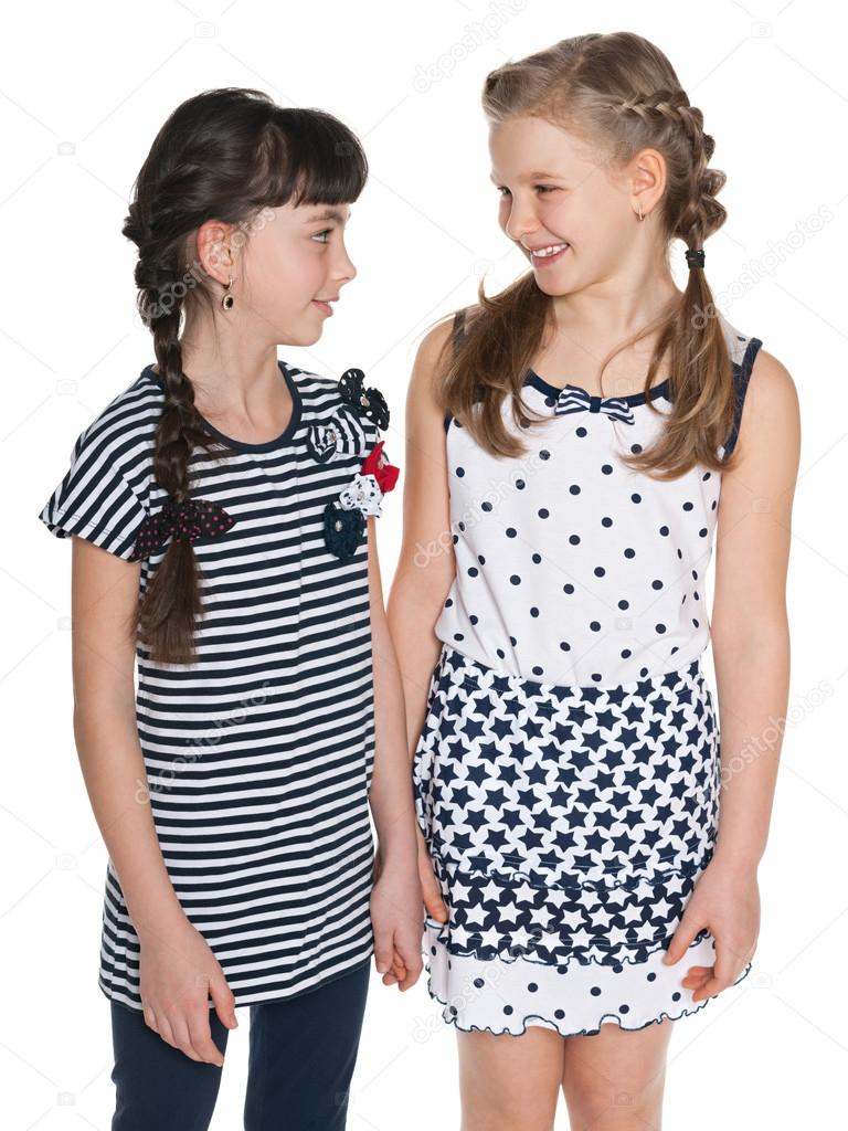 Young girl talks something to her friend