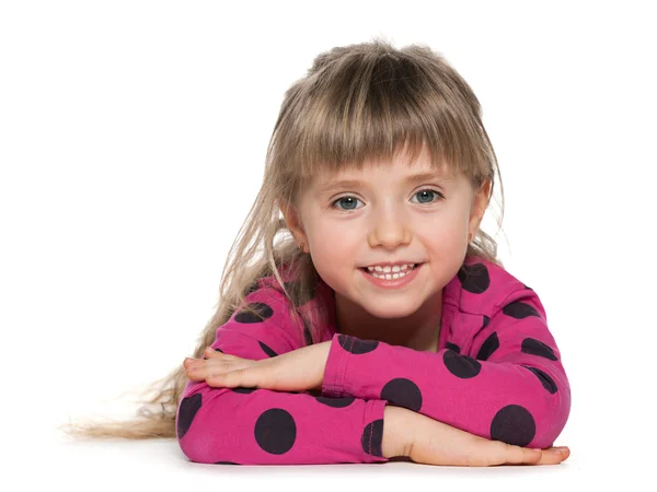 Smiling little girl is lying on the white — Stock Photo, Image