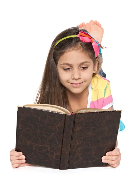 Smiling little girl reads an old book — Stock Photo, Image