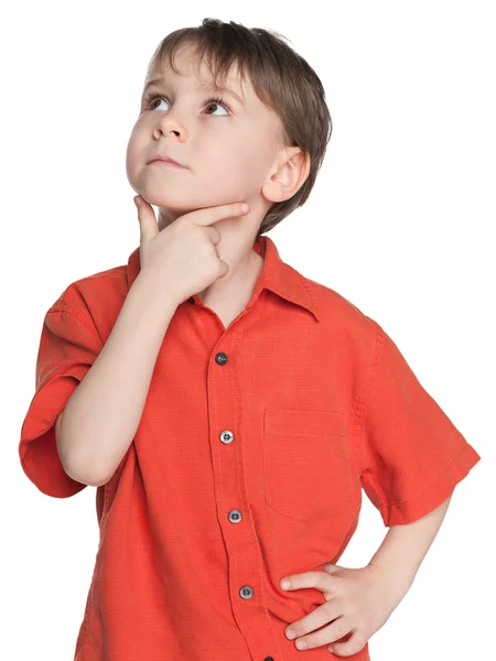 Thoughtful little boy in a red shirt — Stock Photo, Image