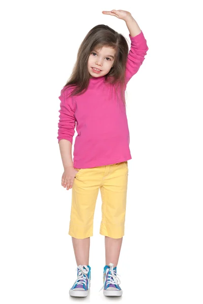Serious little girl showing her height — Stock Photo, Image