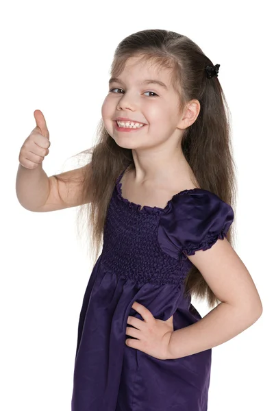 Happy little girl holds her thumb up — Stock Photo, Image