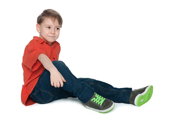 Pensive little boy in the red shirt — Stock Photo, Image