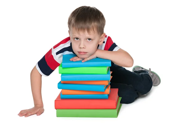 Sad little boy with books — Stock Photo, Image