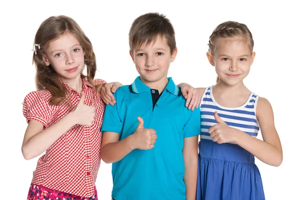 Three cheerful children hold his thumbs up — Stock Photo, Image