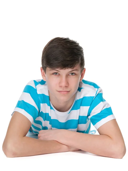 Confident teen boy is lying on the white — Stock Photo, Image