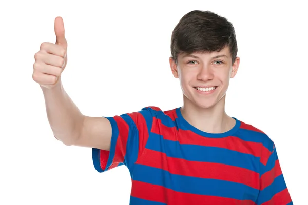 Smiling teen boy holds his thumb up — Stock Photo, Image