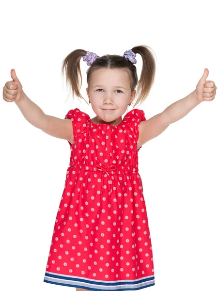 Маленькая улыбающаяся девочка держит большие пальцы вверх — стоковое фото