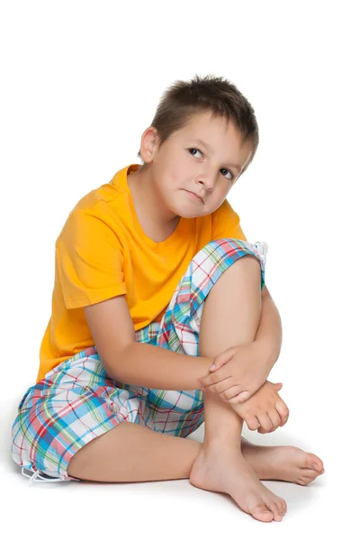 Pensive little boy in the yellow shirt — Stock Photo, Image