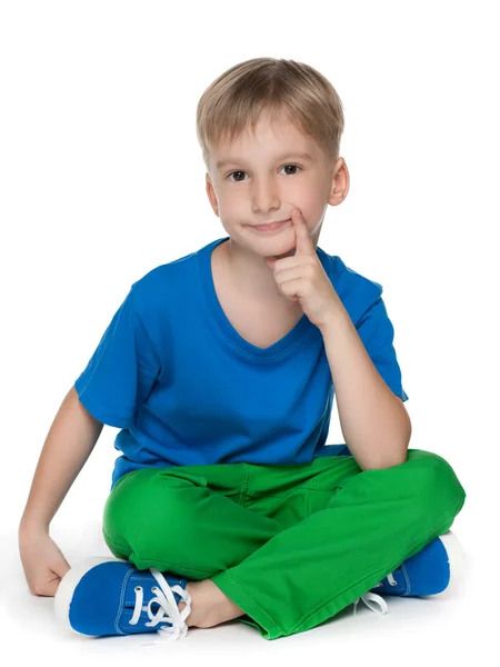 Pensive little boy in the blue shirt — Stock Photo, Image