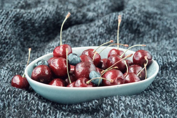 Bowl Full Ripe Red Cherries Dark Blue Knitted Blanket — Stock Photo, Image