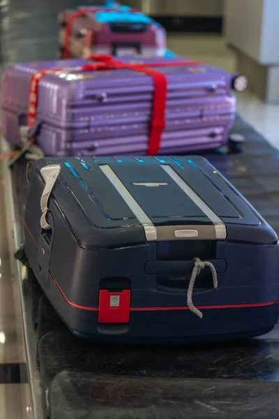 Κάθετη φωτογραφία της βαλίτσας στον ιμάντα μεταφοράς αποσκευών — Φωτογραφία Αρχείου