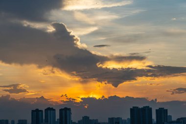 Dramatic beautiful sunset with silhouette of buildings