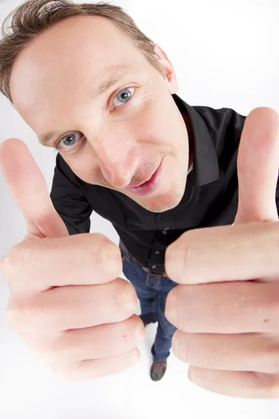 Young man showing thumbs up sign — Stock Photo, Image