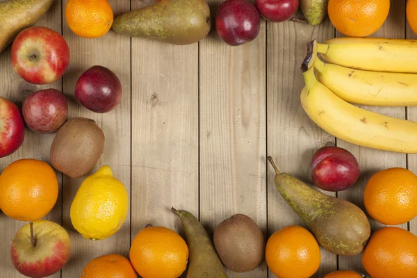 Fruits on wooden plank — Stock Photo, Image