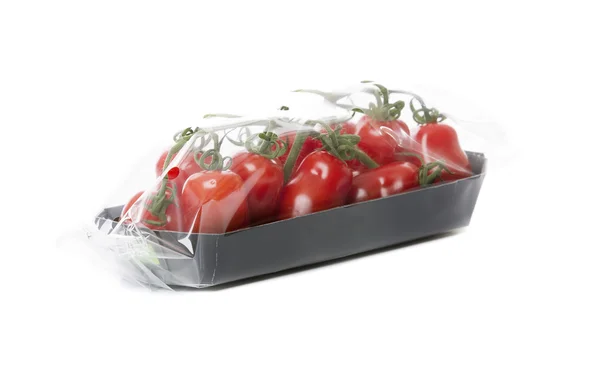 Fresh tomatoes isolated on white background in black tray — Stock Photo, Image
