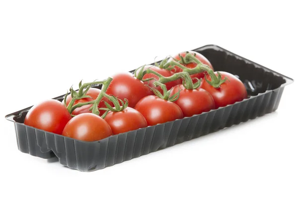 Verse tomaten geïsoleerd op een witte achtergrond in zwarte lade — Stockfoto