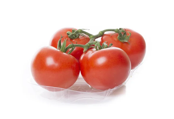 Verse tomaten geïsoleerd op een witte achtergrond in transparant lade — Stockfoto